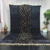 black moroccan rug with a yellow pattern